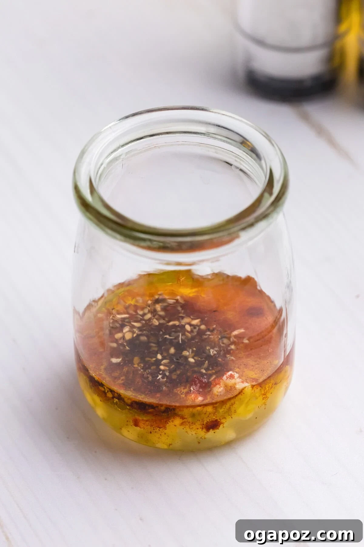 Flavorful Mediterranean Stuffed Butternut Squash Boats 10 Lemon dressing with za'atar and olive oil in a mason jar, ready to be added to the quinoa