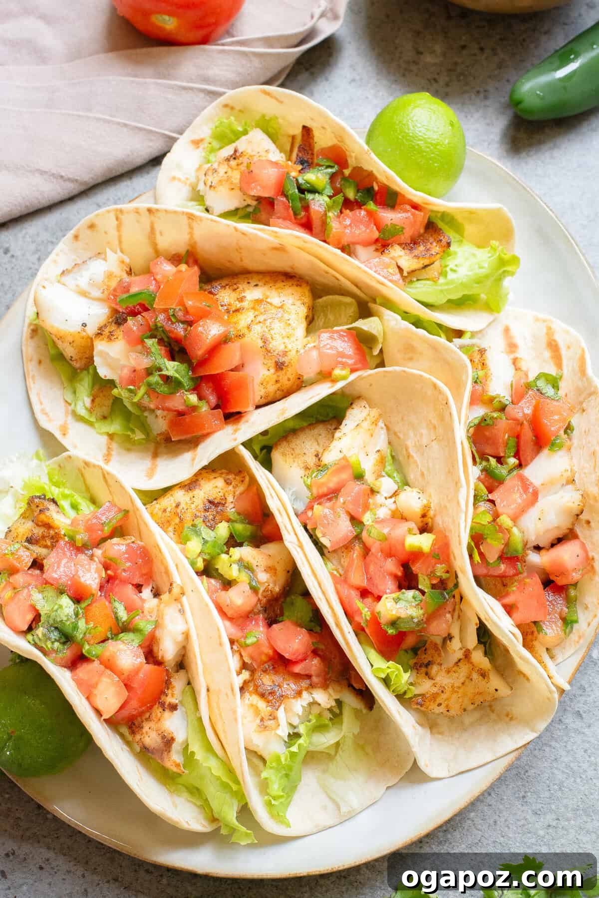 Fiery Fish Tacos 7 Finished Blackened Fish Tacos arranged on a plate with fresh toppings and a side of salsa.