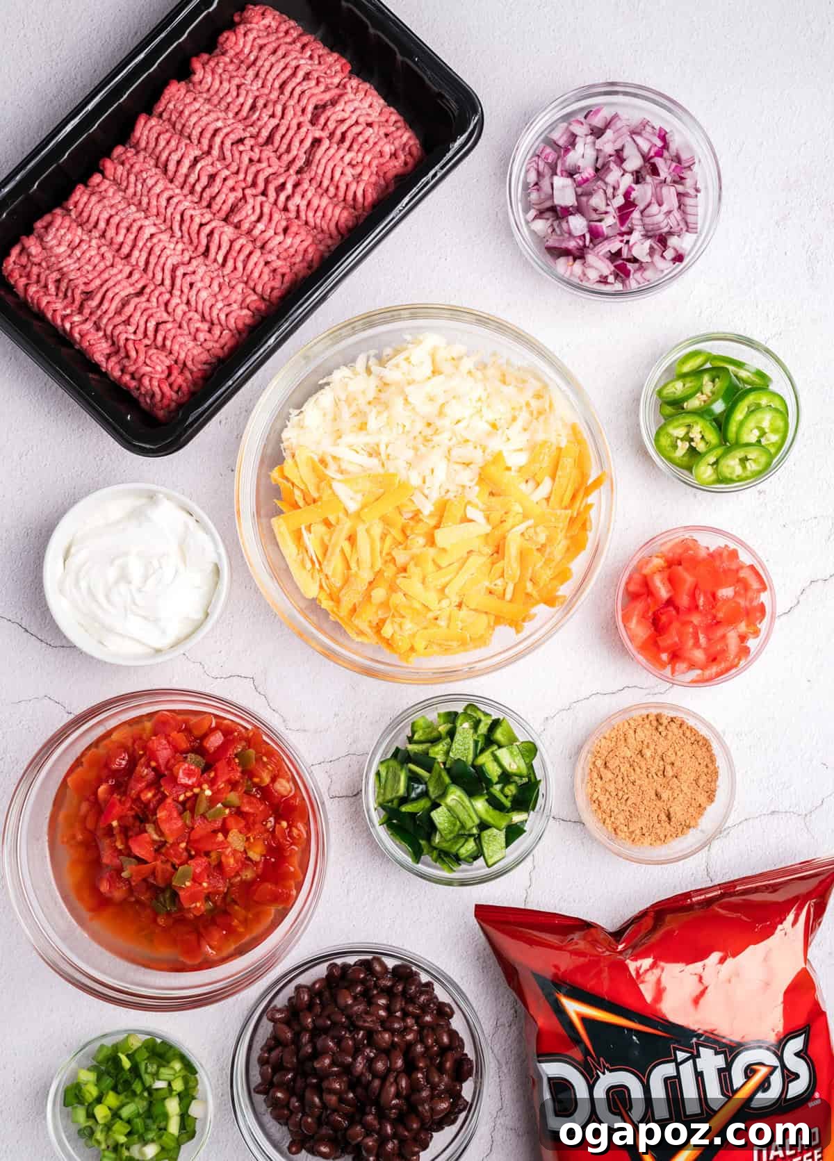 Various ingredients laid out for Doritos Taco Casserole preparation