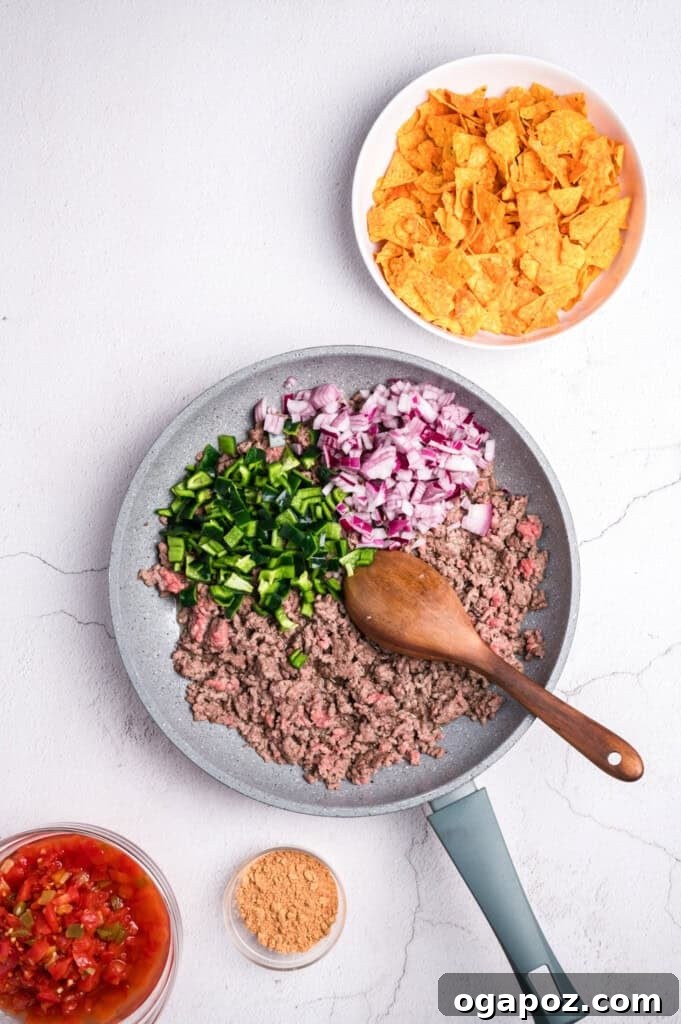 Ground beef cooking in a skillet for taco casserole