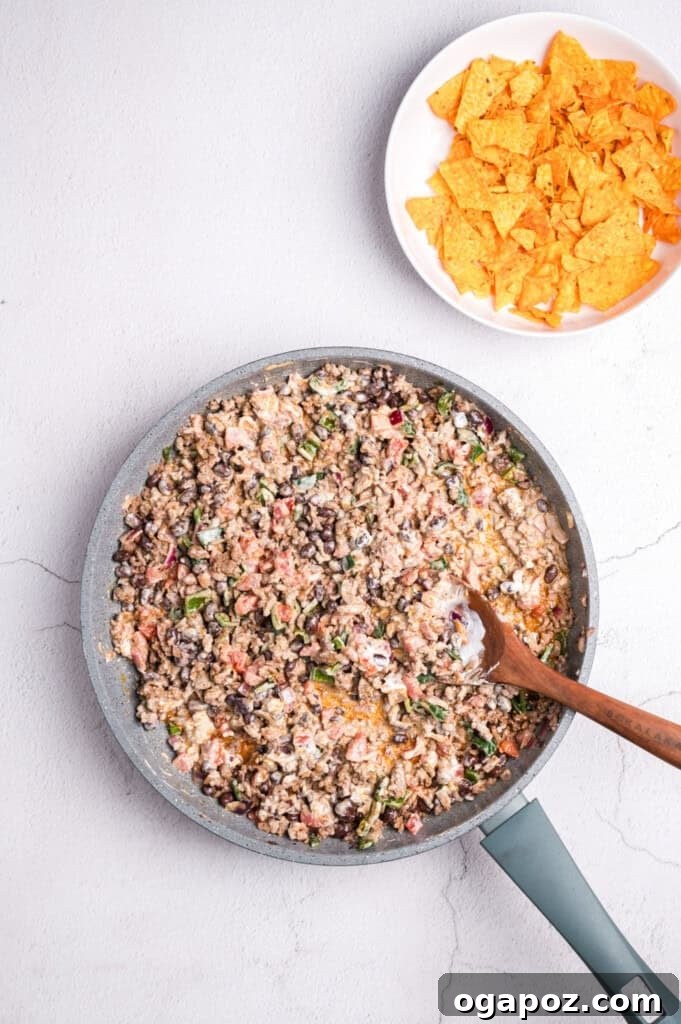 Beef combined with vegetables and seasoning for Doritos Taco Casserole