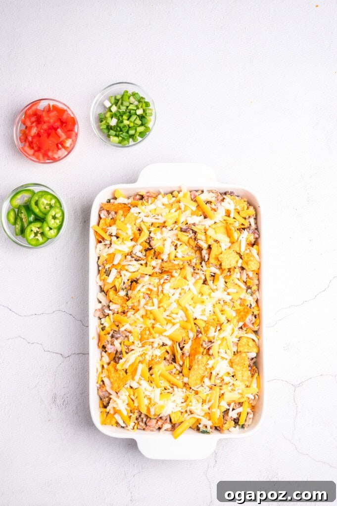 Doritos Taco Casserole assembled in a baking dish, ready for the oven