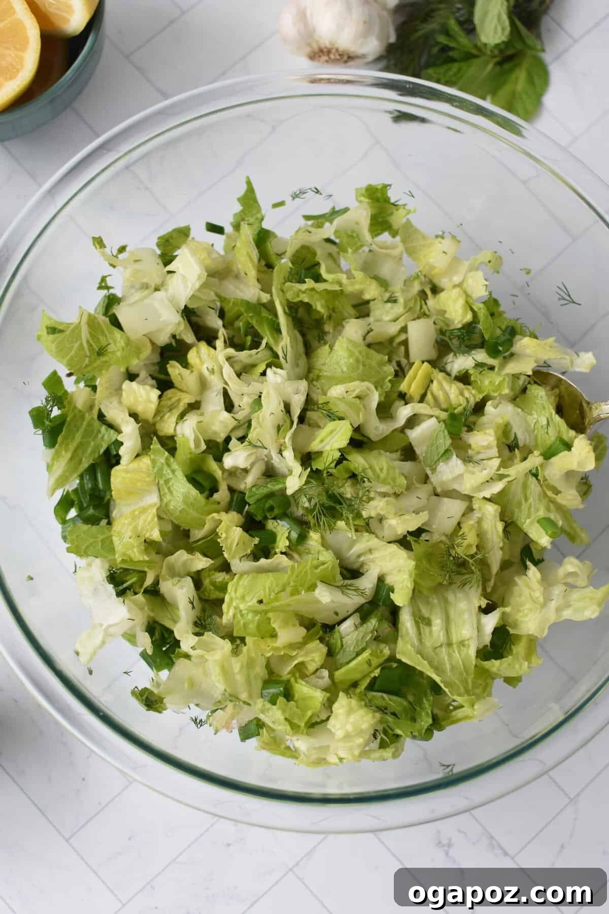 Vibrant Greek Lettuce and Dill Salad 10 Maroulosalata in a clear glass bowl, showcasing its vibrant colors
