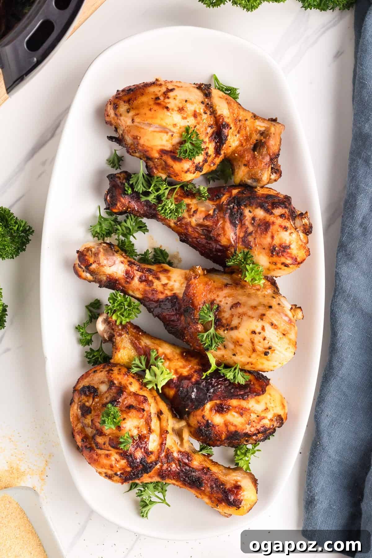 Extra Crispy Air Fried Drumsticks 7 Crispy Air Fryer Chicken Legs on a white platter ready to be served