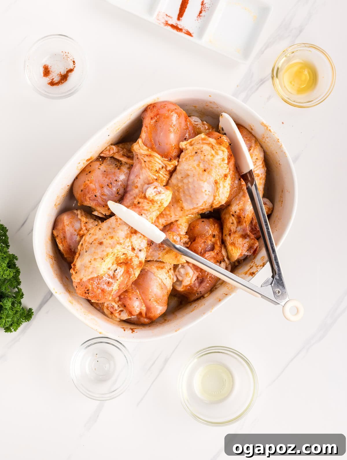 Extra Crispy Air Fried Drumsticks 8 Crispy Air Fryer Chicken Legs being tossed in seasoning with tongs
