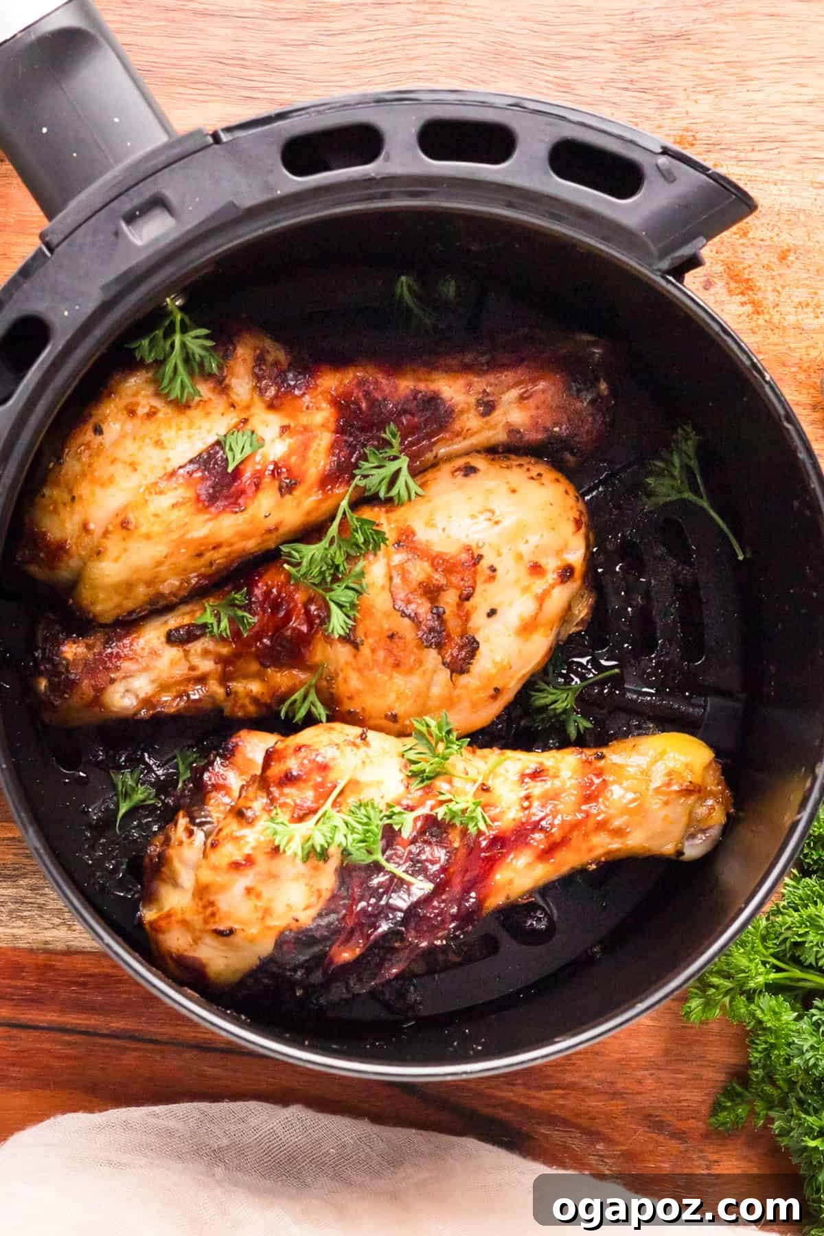 Extra Crispy Air Fried Drumsticks 9 Crispy Air Fryer Chicken Legs cooking in an air fryer basket