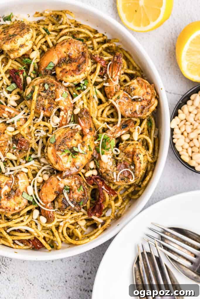 Vibrant Pesto Shrimp Pasta 2 Delicious Shrimp Pesto Pasta in a bowl, garnished with fresh basil