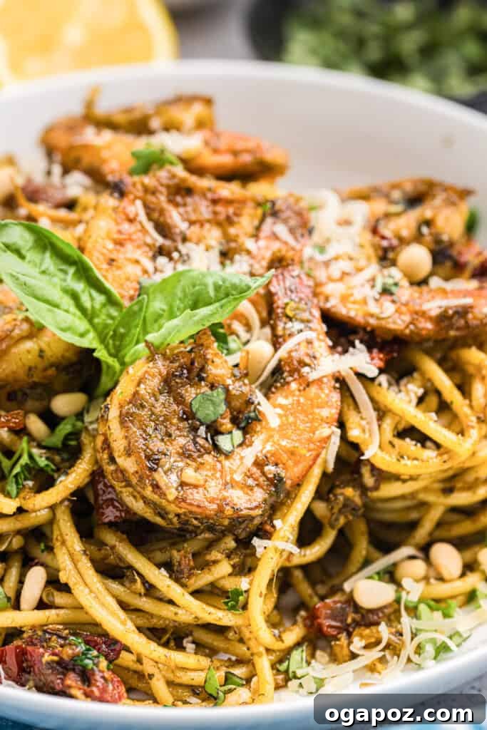 Vibrant Pesto Shrimp Pasta 11 Close-up of Shrimp Pesto Pasta in a bowl, showing texture and fresh basil garnish