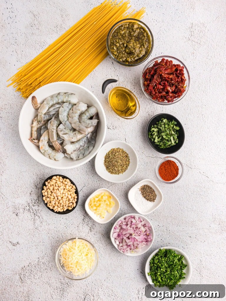 Vibrant Pesto Shrimp Pasta 5 Arrangement of fresh ingredients for Shrimp Pesto Pasta, including pasta, shrimp, sun-dried tomatoes, and basil