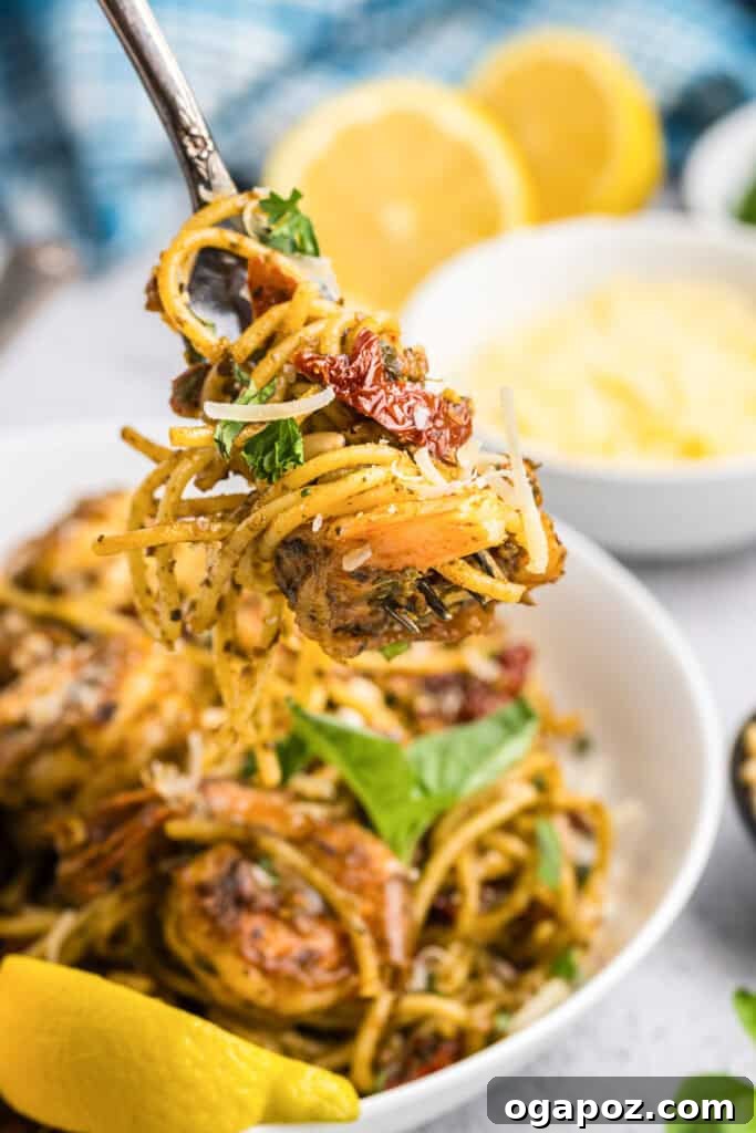 Vibrant Pesto Shrimp Pasta 6 Shrimp Pesto Pasta served on a fork, showing the texture and ingredients
