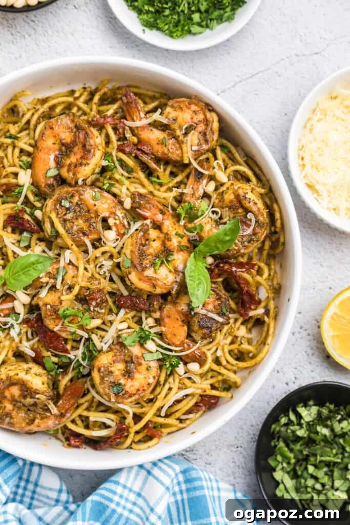 Vibrant Pesto Shrimp Pasta 7 Shrimp Pesto Pasta garnished with fresh basil leaves