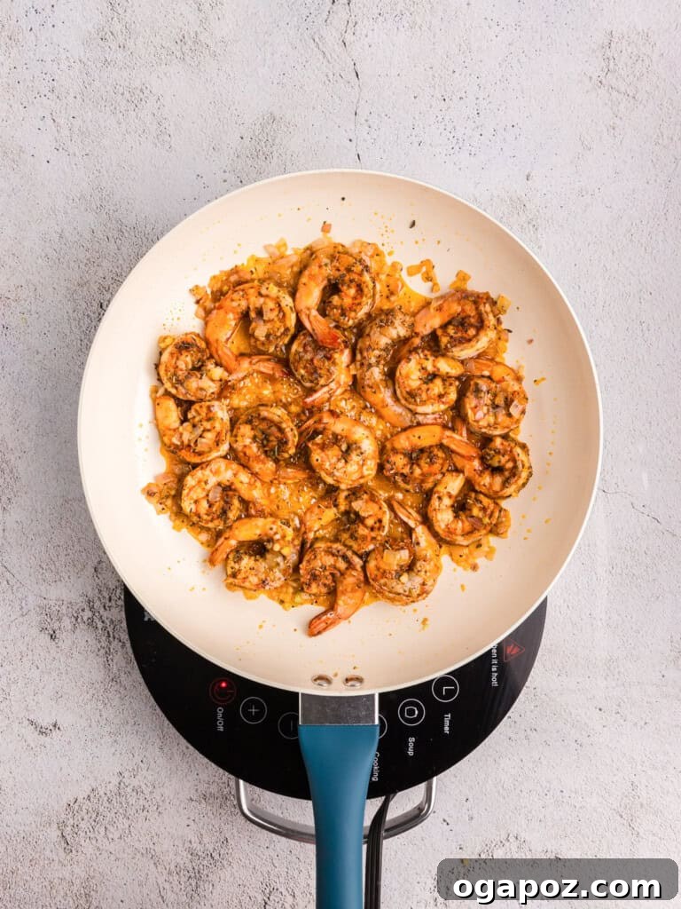 Vibrant Pesto Shrimp Pasta 9 Shrimp and shallots cooking in a skillet