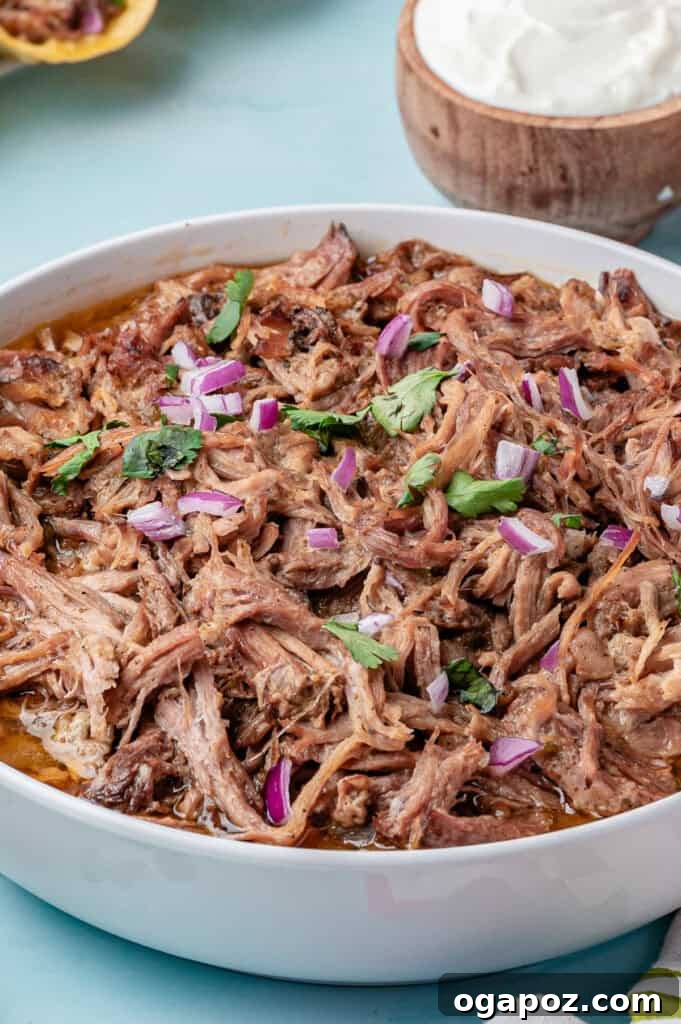 Tender Slow Cooker Pulled Pork Tacos 2 Delicious Slow Cooker Pulled Pork Tacos served in a large bowl, ready to be assembled