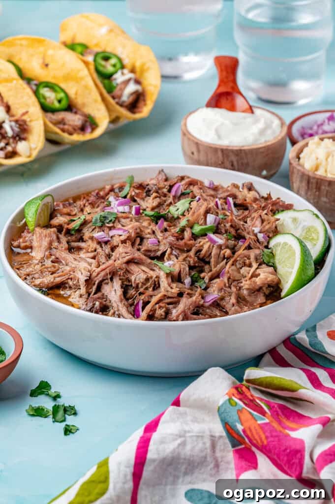 Tender Slow Cooker Pulled Pork Tacos 11 A large bowl brimming with Slow Cooker Pulled Pork, ready to be served or used in various dishes