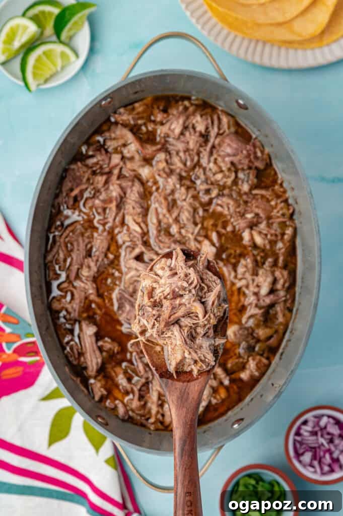Tender Slow Cooker Pulled Pork Tacos 10 Close-up view of Slow Cooker Pulled Pork simmering in the crockpot, showing its tenderness