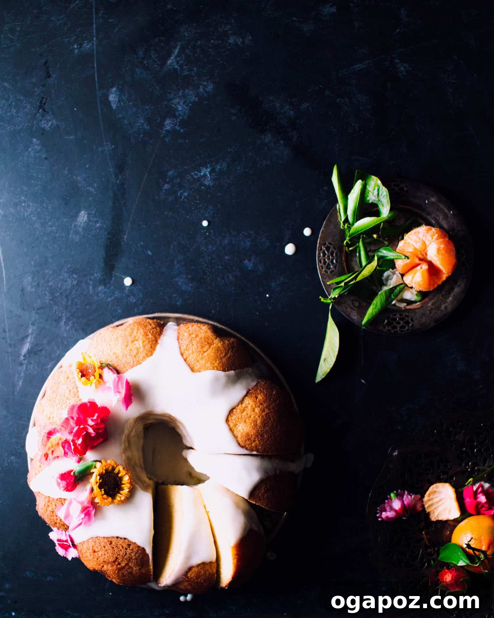 Beautifully glazed orange Bundt cake resting on a wire cooling rack, highlighting its intricate design and golden-orange hue