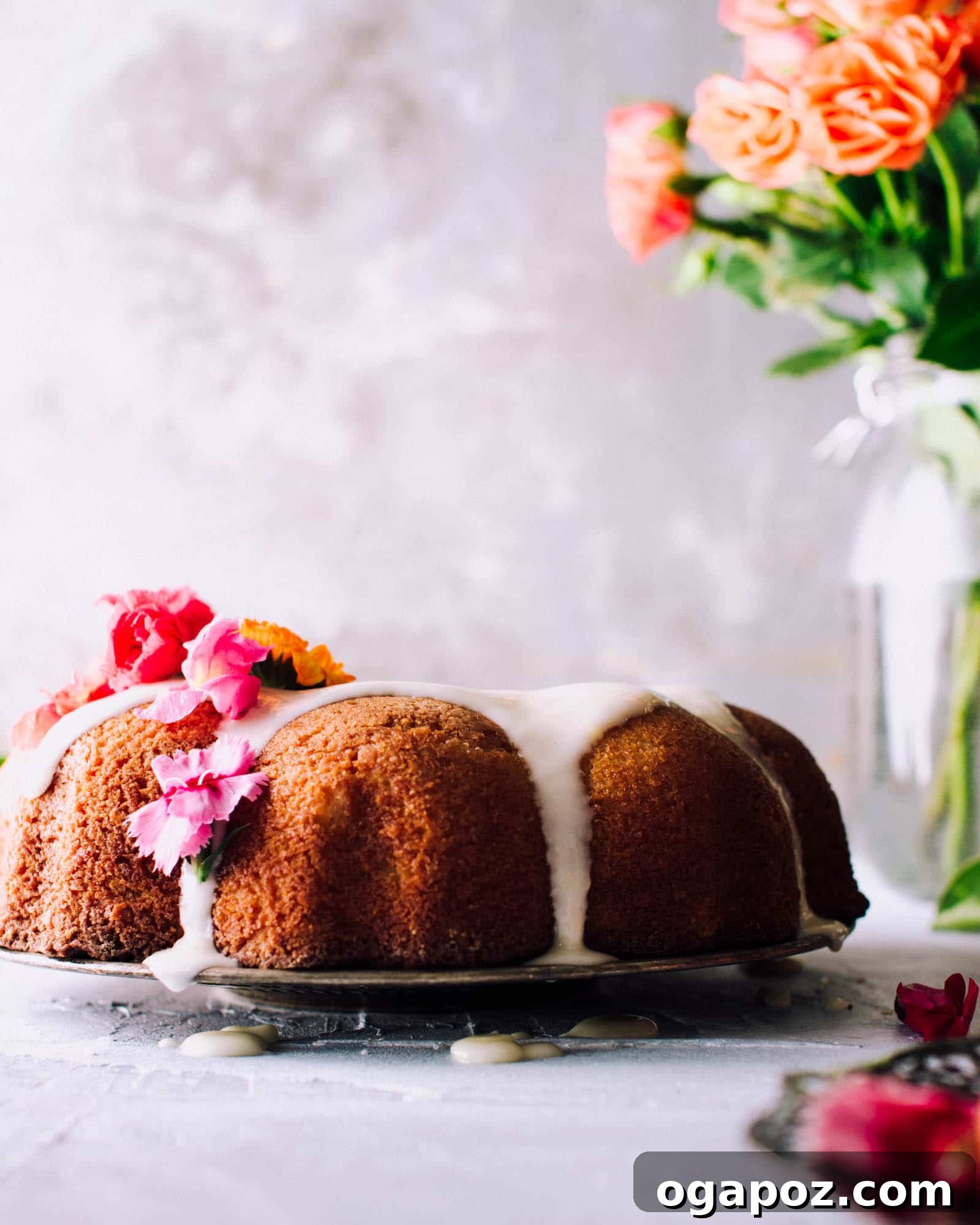Top-down view of a delectable orange Bundt cake with a vibrant, glistening orange glaze, ready for slicing