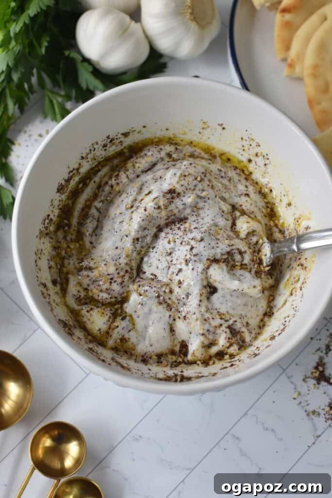 One Pan Roasted Zaatar Chicken 11 Greek yogurt being mixed in a bowl, ready for the marinade.