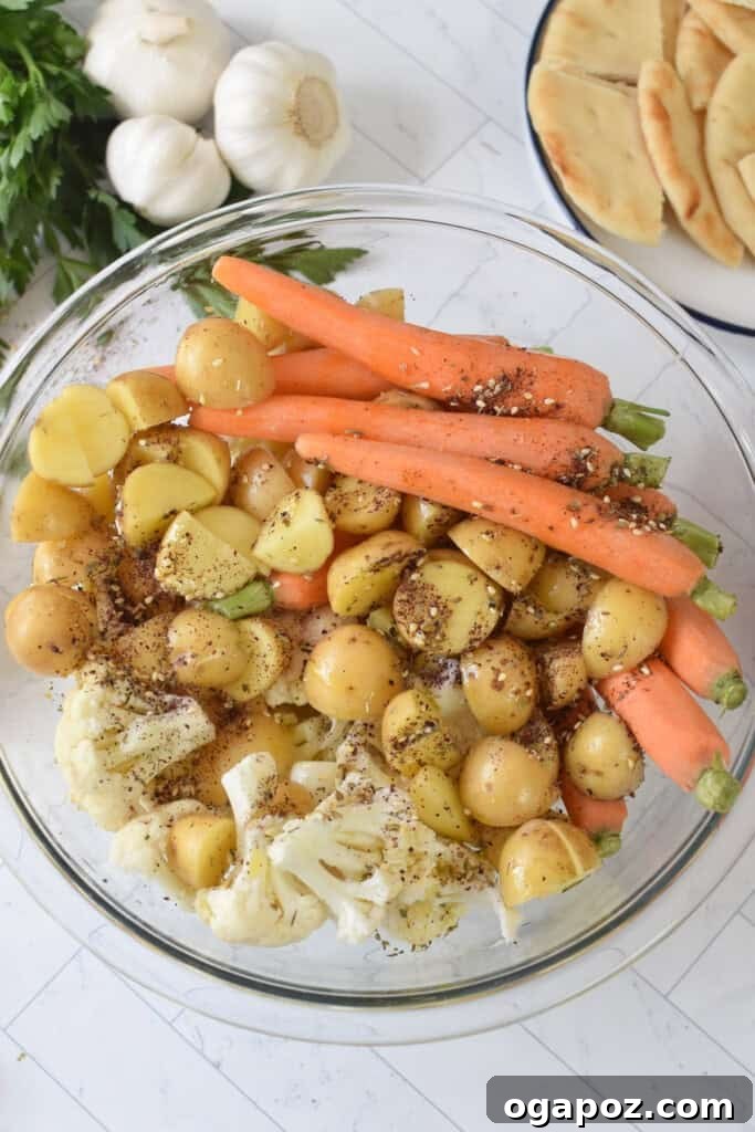 One Pan Roasted Zaatar Chicken 13 A bowl of mixed potatoes and vegetables seasoned with za'atar.