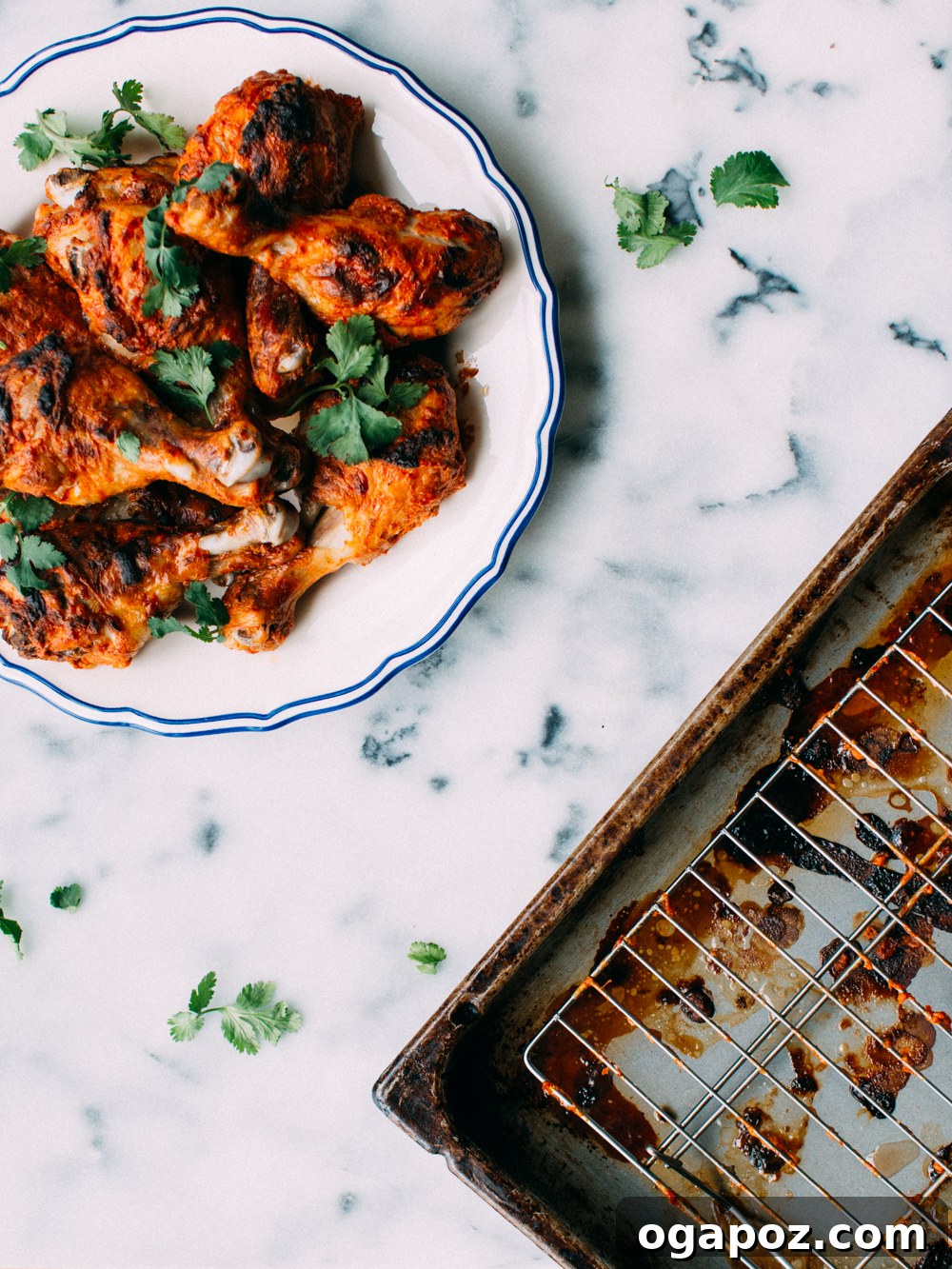 Succulent Baked Tandoori Chicken 5 A vibrant plate of Tandoori Chicken served with basmati rice, raita, and naan bread, garnished with fresh cilantro and lemon.