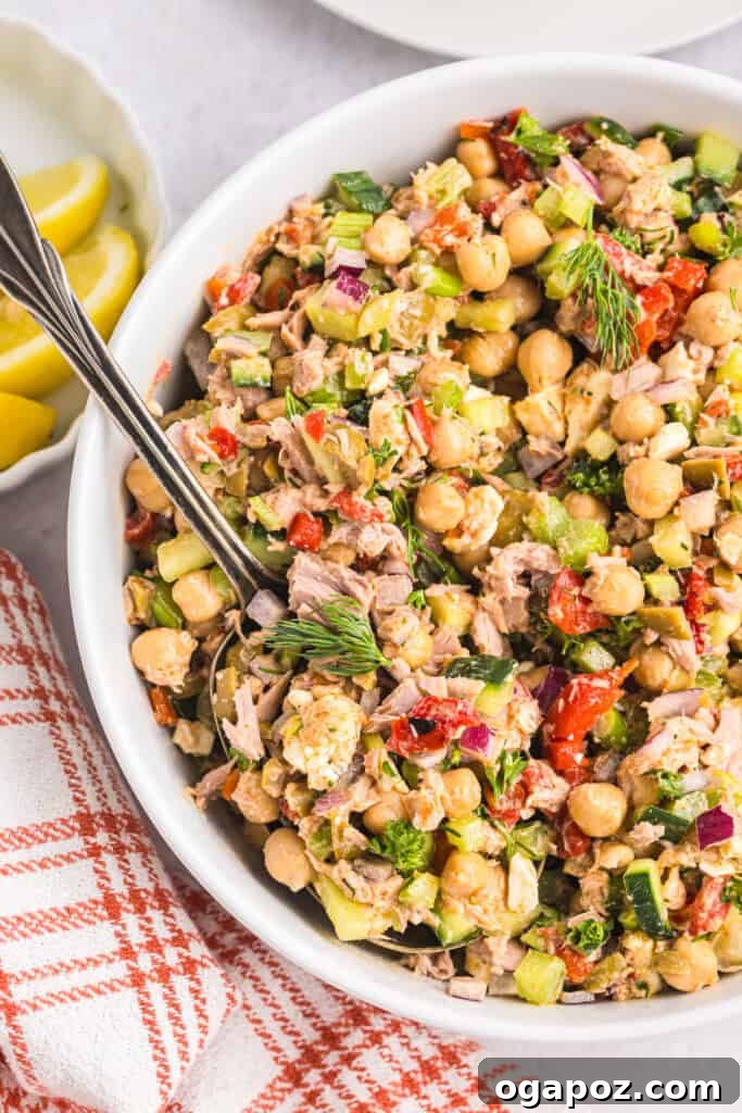 Sun-Kissed Mediterranean Tuna and Chickpea Delight 2 Mediterranean Tuna and Chickpea Salad with a spoon
