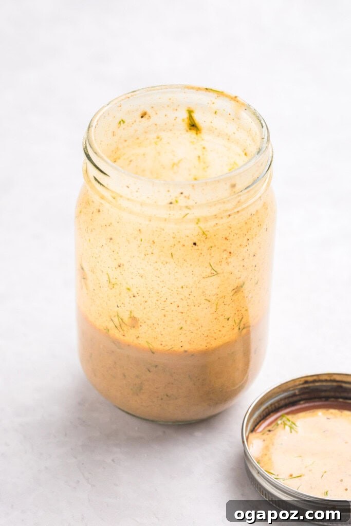 Sun-Kissed Mediterranean Tuna and Chickpea Delight 10 Mediterranean Tuna and Chickpea Salad dressing ingredients in a mason jar