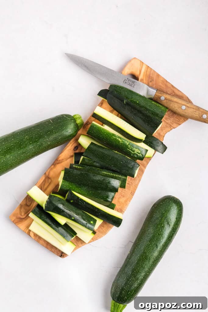 Zucchini being sliced into fry shapes