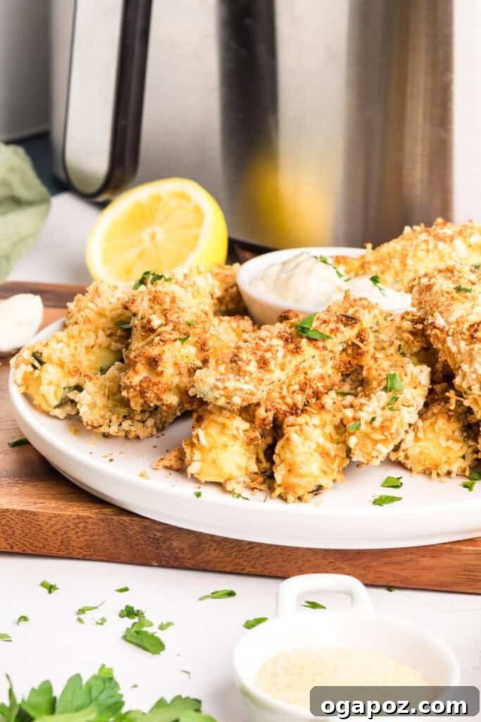 Air Fryer Zucchini Fries displayed next to an air fryer