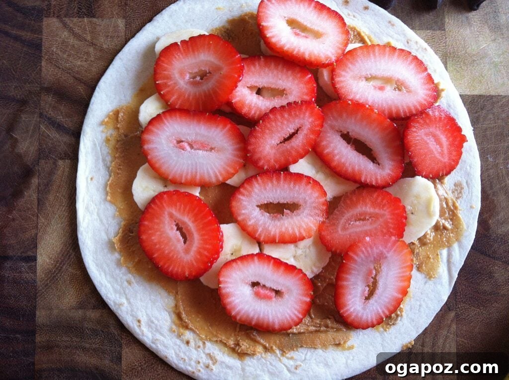 Heavenly Sweet Quesadillas 7 Freshly sliced strawberries layered over bananas and peanut butter on a tortilla, adding color and sweetness.