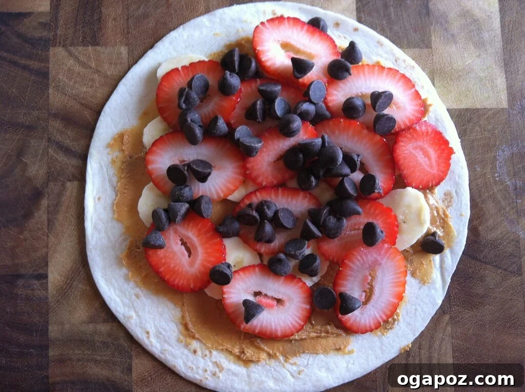 Heavenly Sweet Quesadillas 8 Chocolate chips scattered generously over the layers of strawberries, bananas, and peanut butter on a tortilla.