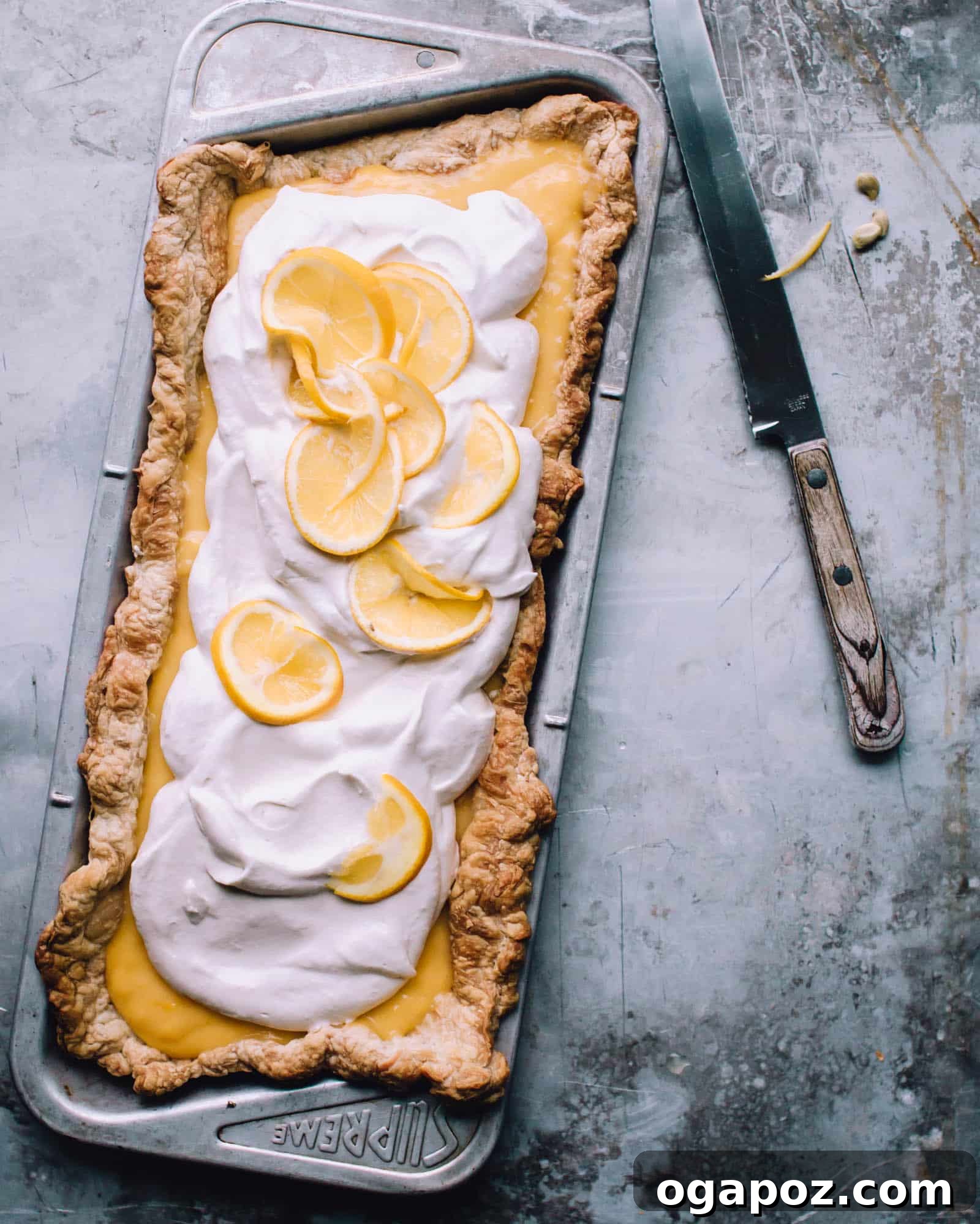 Effortless Zesty Lemon Tart 2 Easy Lemon Tart in a pan, showcasing its golden crust and vibrant yellow filling.