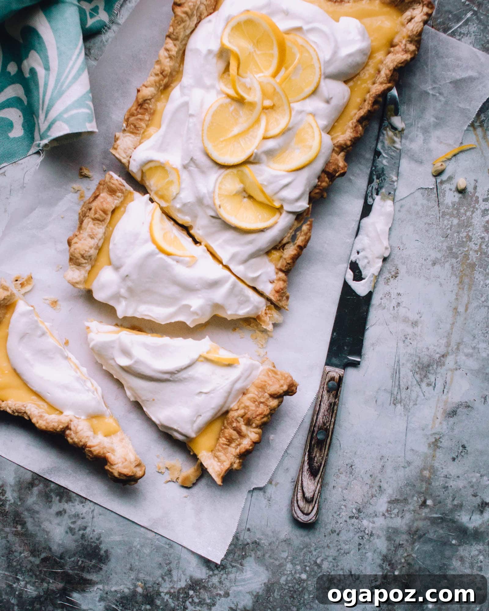 Effortless Zesty Lemon Tart 4 Easy Lemon Tart sliced on parchment paper, ready to be served.