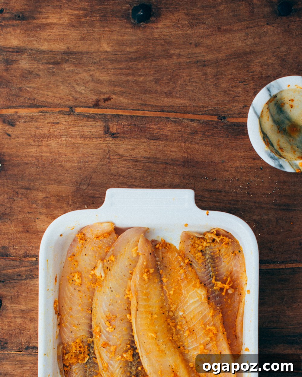 Authentic Kerala Fish Fry 4 Marinating the fish in a vibrant spice paste for an Indian fried fish recipe, showcasing the rich colors of the marinade.