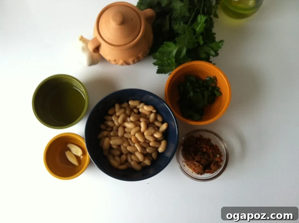 Simple Ingredients for a Flavorful Dip Fresh ingredients for White Bean and Sun-Dried Tomato Dip laid out on a cutting board