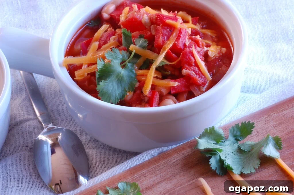 Hearty Turkey White Bean Chili 3 Close-up of a rustic bowl of chili with a spoon, highlighting the texture, tender turkey, and creamy white beans.