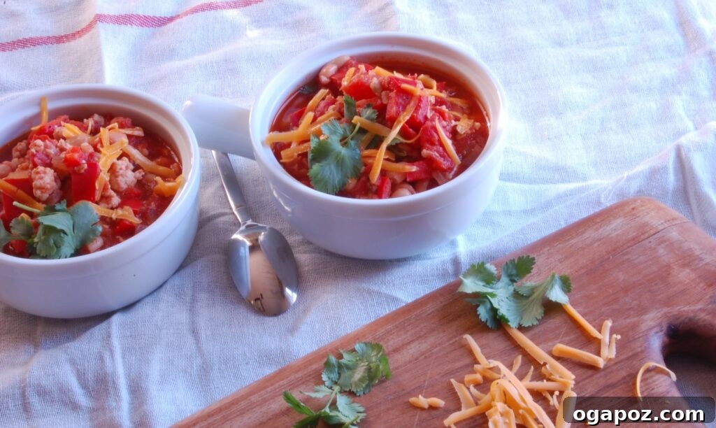 Hearty Turkey White Bean Chili 4 A cozy, steaming bowl of Turkey and White Bean Chili with a fresh lime wedge and cilantro garnish, ready to be enjoyed.