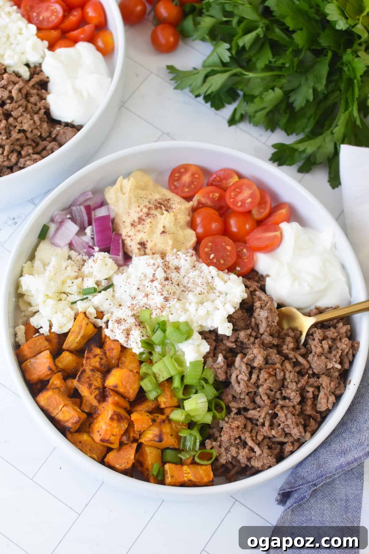 Ground Beef Sweet Potato Cottage Cheese Bowls 6 A close-up of a Sweet Potato Cottage Cheese Bowl, with a golden fork showing the various layers.