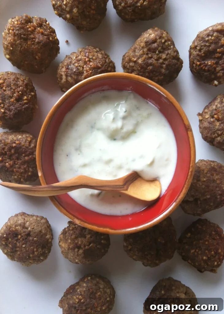 Savory Kibbeh with Tangy Spiced Yogurt 4 Close-up of Kibbeh Meatballs with Spiced Yogurt Sauce, ideal as an appetizer