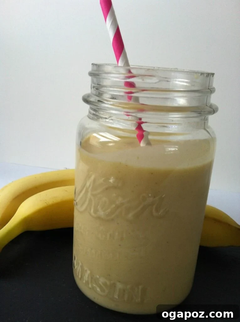 Sunrise Mango Banana Oatmeal Smoothie 2 Vibrant Mango Banana Oatmeal Breakfast Smoothie in a glass, ready to be enjoyed.