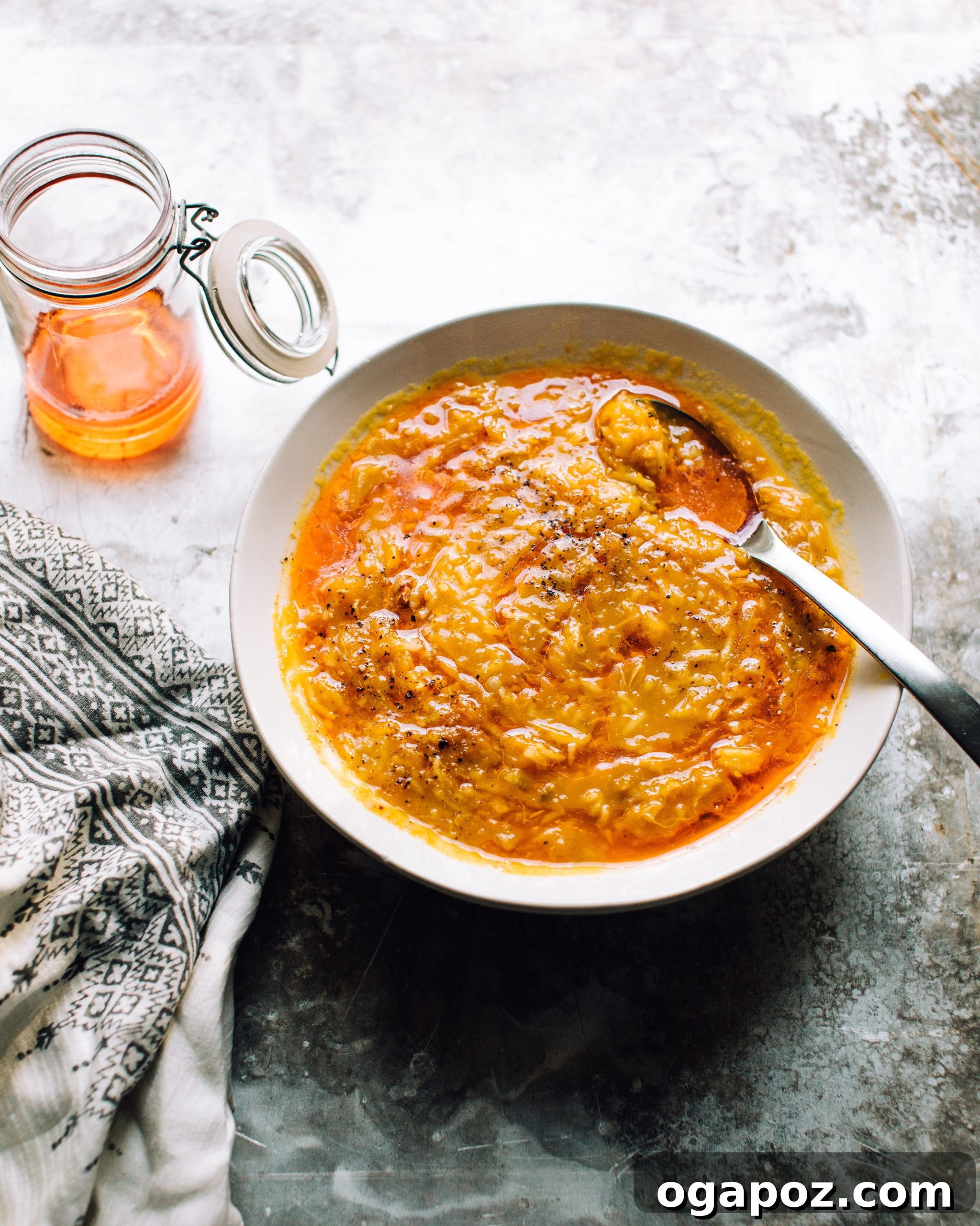Hearty Pumpkin Rice Soup with Warming Ginger 2 Rich and creamy Pumpkin Soup with Ginger and Rice, garnished with a swirl of chili oil, perfect for autumn