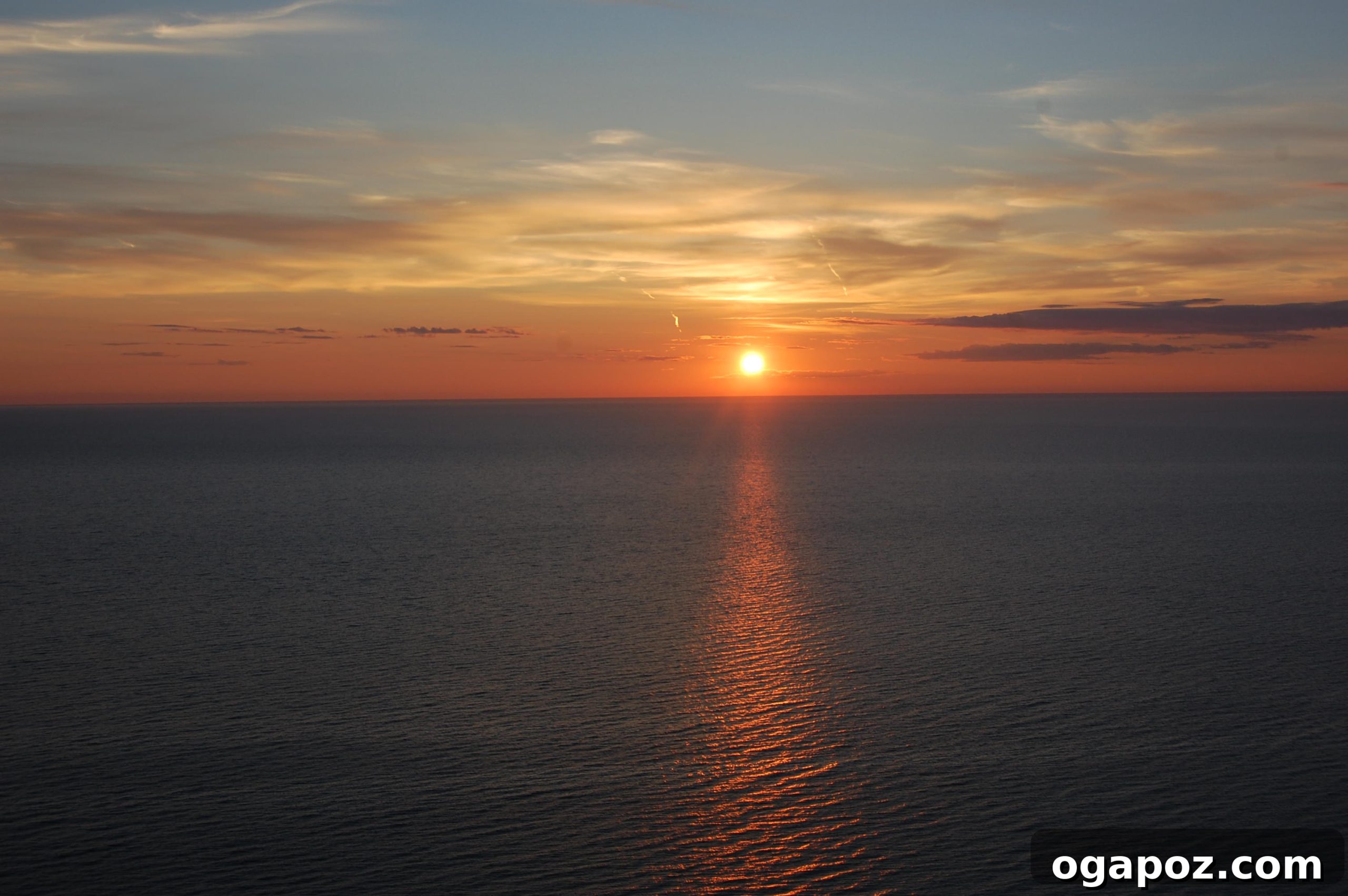 Panoramic Sunset View A panoramic shot capturing the fiery colors of the sunset illuminating the horizon at Sleeping Bear Dunes.