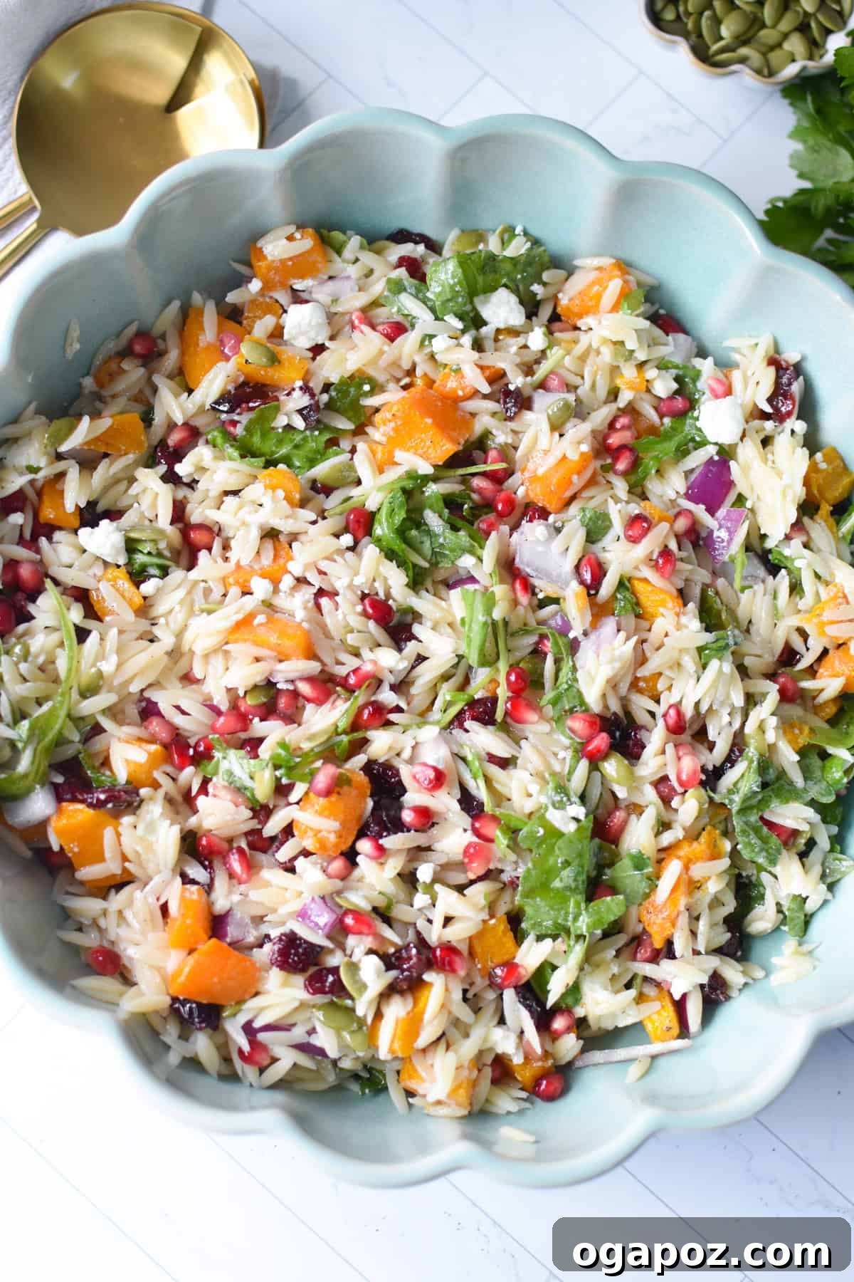 Autumn Harvest Orzo Pasta Salad 2 Fall Orzo Pasta Salad artfully arranged in a teal bowl with elegant gold spoons, showcasing vibrant colors and textures.