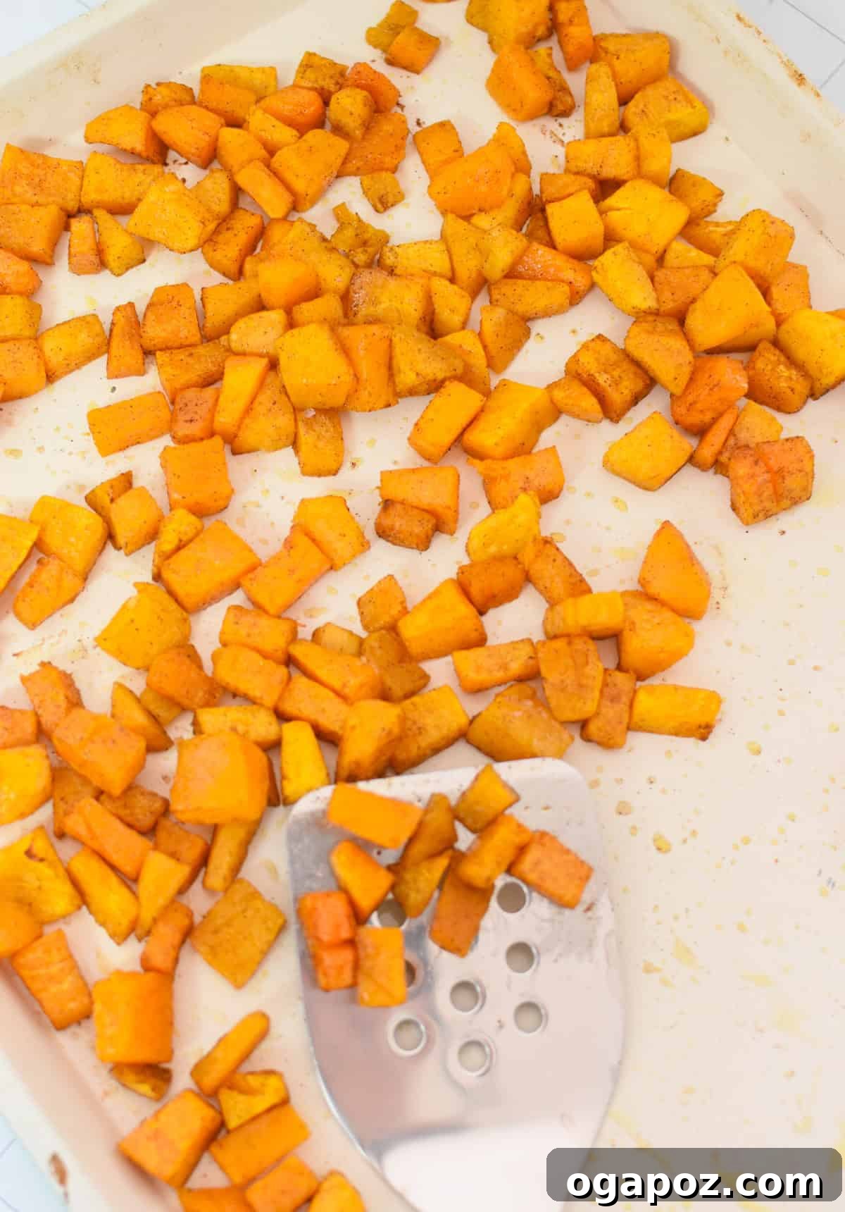 Autumn Harvest Orzo Pasta Salad 9 Perfectly roasted butternut squash, tender and lightly browned, cooling on a baking sheet after being removed from the oven.