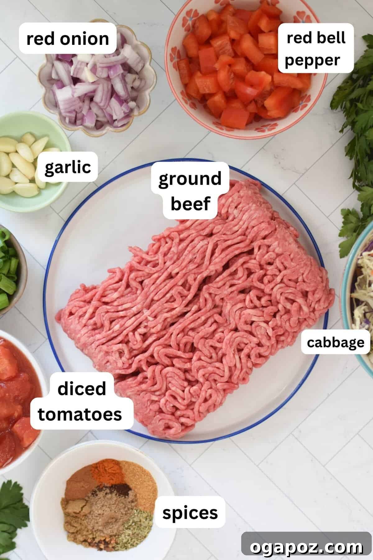 Rustic Mediterranean Beef and Cabbage Stir-fry 5 Various fresh ingredients laid out for Mediterranean Beef and Cabbage Stir-fry, including ground beef, spices, vegetables, and canned goods.