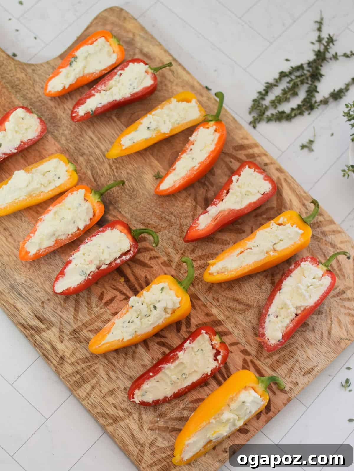 Creamy Goat Cheese Stuffed Mini Peppers 10 Mini sweet peppers stuffed with goat cheese mixture, neatly arranged on a cutting board
