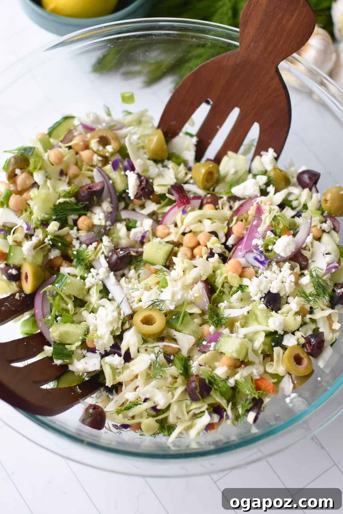 Zesty Greek Cabbage Slaw 2 Large bowl filled with vibrant Greek Cabbage Slaw Salad, ready to be served, showcasing its fresh ingredients and enticing colors.
