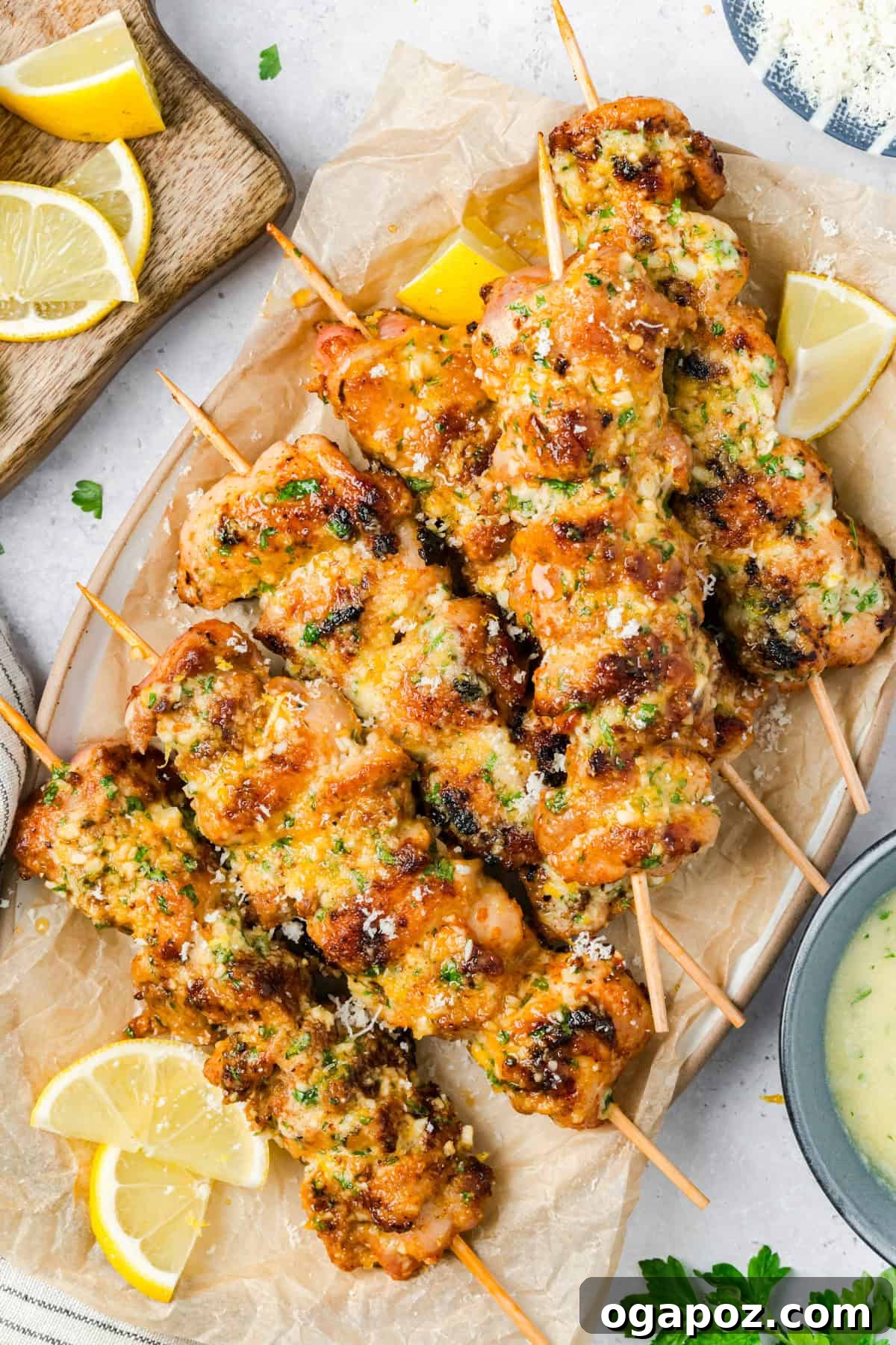 Golden Garlic Parmesan Chicken Skewers 6 Grilled Chicken Skewers being brushed with Parmesan, Garlic, and Butter sauce.