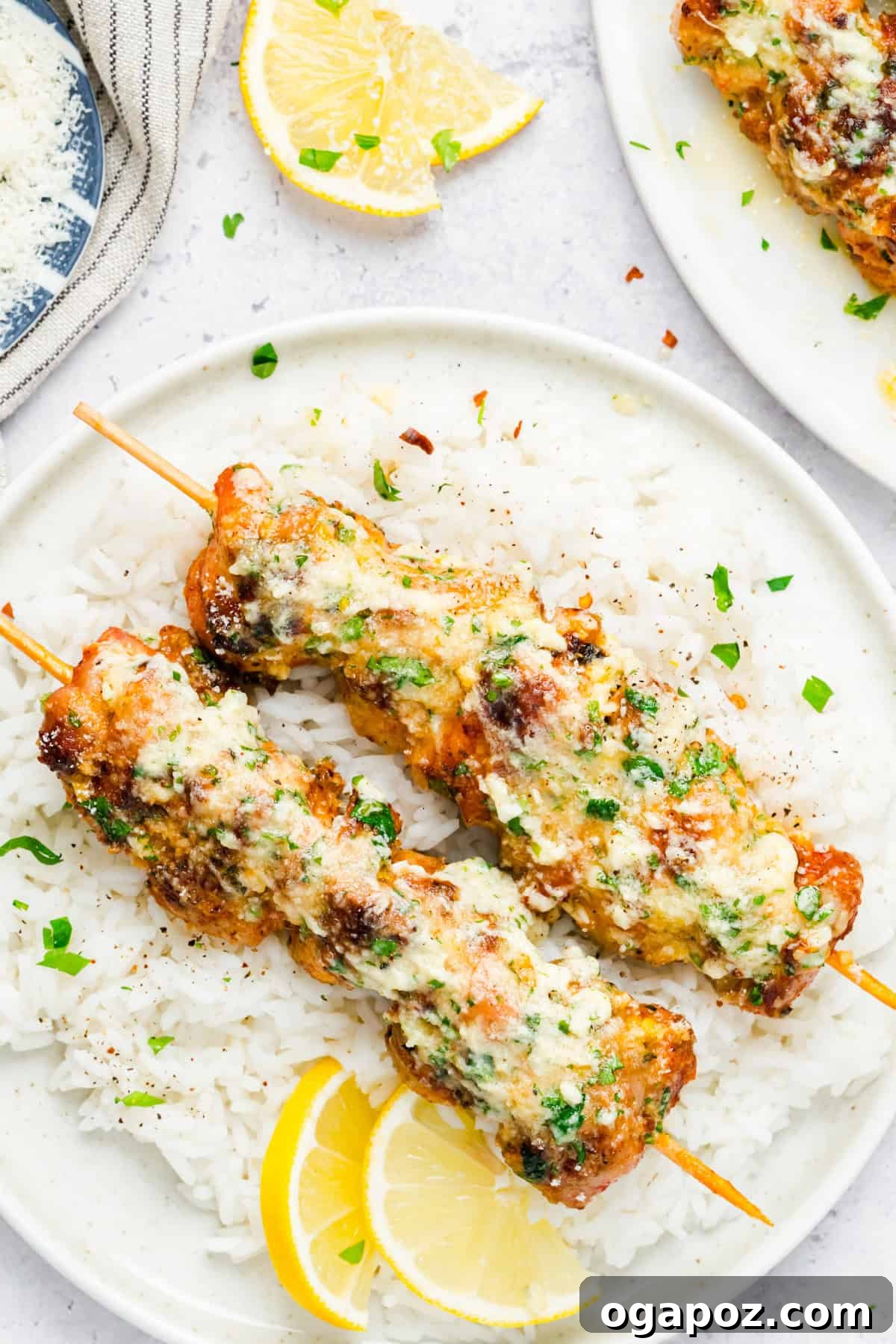 Golden Garlic Parmesan Chicken Skewers 7 Juicy Grilled Chicken Skewers Brushed with Garlic Parmesan Butter Sauce, garnished with fresh parsley and lemon.