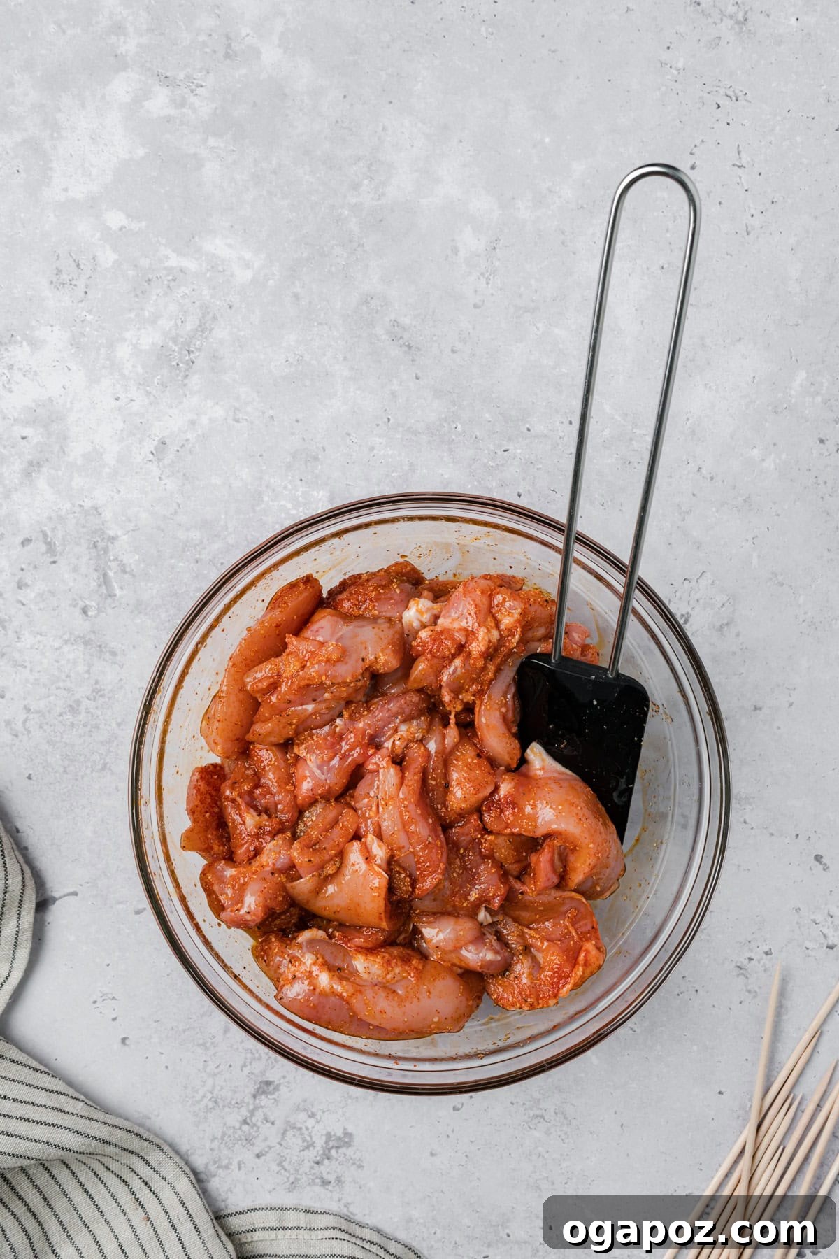 Golden Garlic Parmesan Chicken Skewers 8 Chicken pieces in a bowl, coated in marinade for Garlic Parmesan Chicken Skewers.