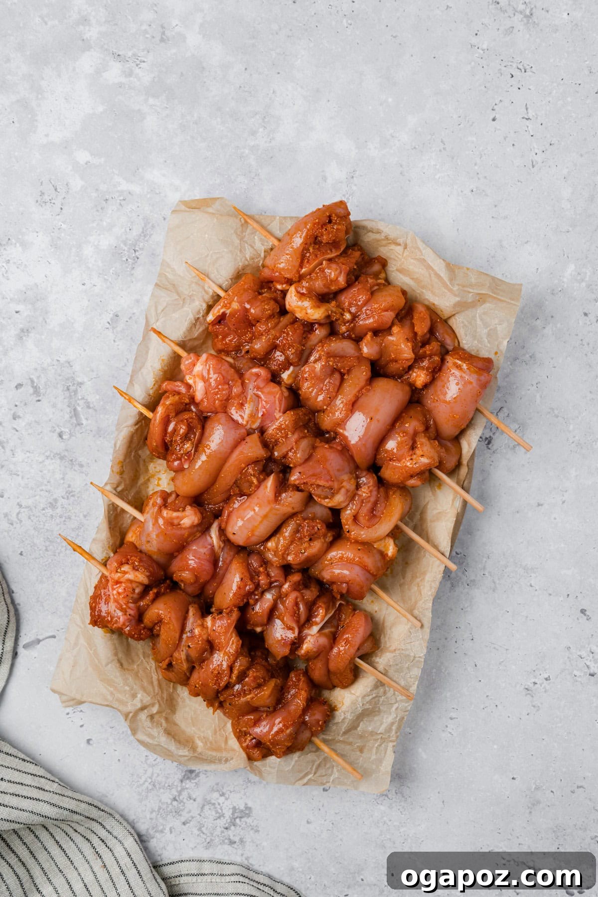 Golden Garlic Parmesan Chicken Skewers 9 Marinated chicken pieces threaded onto wooden skewers.